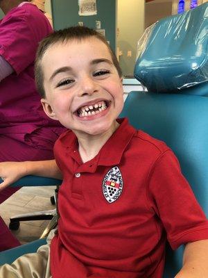 My happy kid showing off his clean teeth.