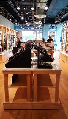 Store interior, from the back looking towards the front. Can see all the natural sunlight streaming into the front part of the store.