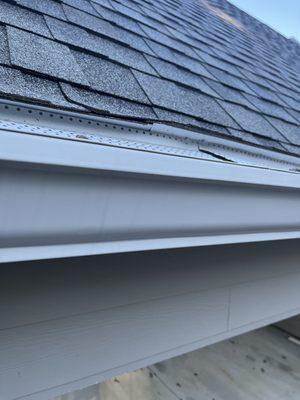 Drip Edge installed too high pushing up the shingles causing water to flow behind the gutters