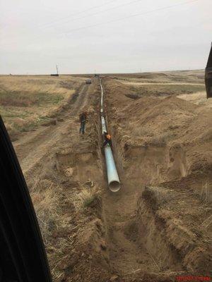 Here the team is laying 20" steel pipe for a new mainline that will supply water to about 1,000 acres of land that was dryland farmed.