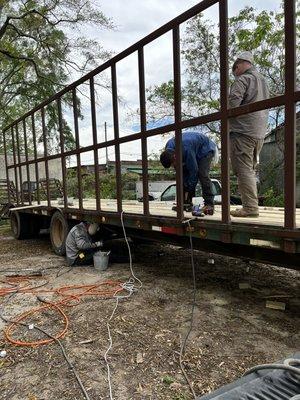 Repairs being made on farm trailer