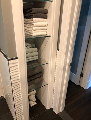 Thick glass shelving in bathroom area