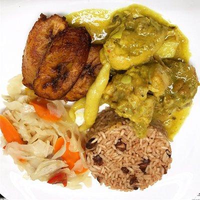 Curry chicken served with rice & peas, steamed cabbage & plantains