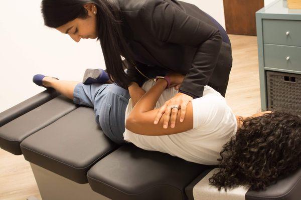 Diversified lumbar spine adjustment to ease low back pain.