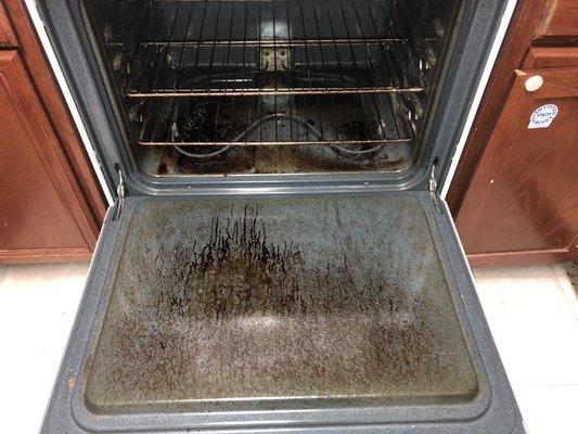 Before pic of an oven cleaned by an Elite team member.