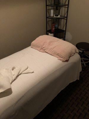 The massage table. No blanket just a sheet and towel.