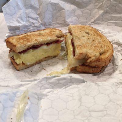 Egg, provolone, turkey bacon on toasted sunflower seed bread. Perfectly made!