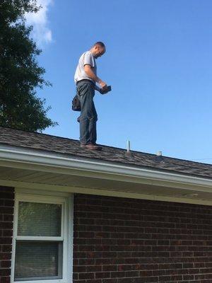 Mat inspecting a roof.