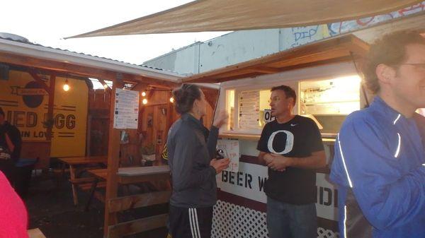 The owner helping a HHH determine what beer she might like better than a Hamm's at one of their beer checks.