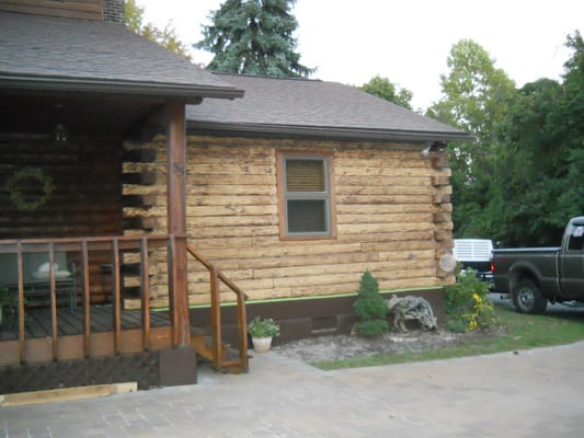 Stain was removed from the right side of this log cabin