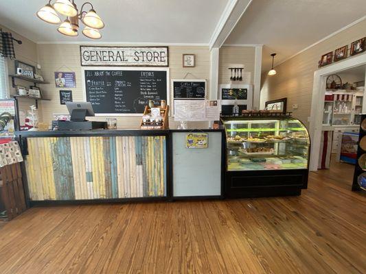 Main room with menu, bakery goods, coffee and treats.