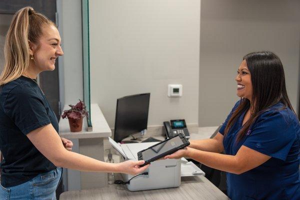 Patient checking in at Good Faith Dentistry for their dental appointment