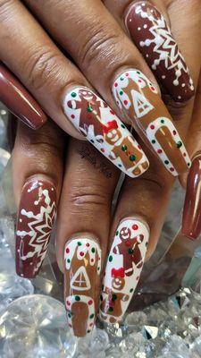 Fill in on long nails.Gingerbread christmas designs all hand painted with gel polish.