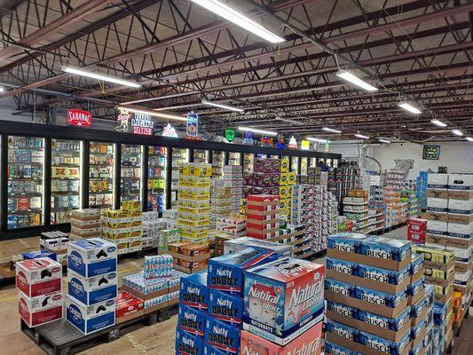 The cooler room with larger cases of domestic and foreign beers.