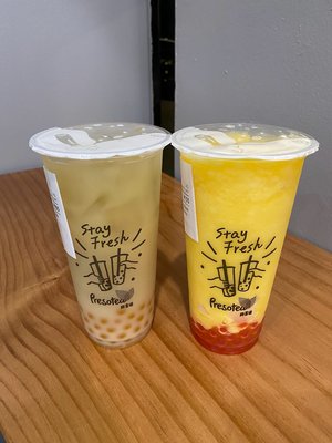 White Peach Milk Tea with Peach Boba, 30% sugar (left); Mango Pineapple Slush w/Strawberry Popping Boba (right)