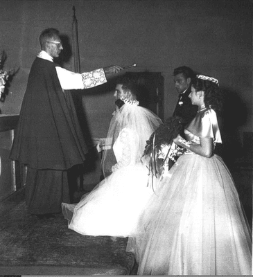 Msgr. Arthur Scanlan is shown here blessing the marriage of Arthur and Norma Panetta on Sept. 19, 1953.  The Panettas had three children.