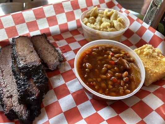 Brisket dinner with baked beans, mac and cheese and tender sweet corn bread.