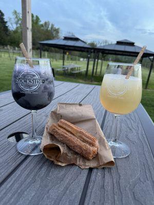 Wine slushes, churros (from food truck), and outdoor seating. You can see the vineyard all around.