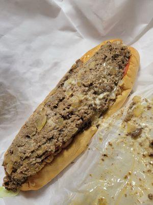 Cheesesteak with onions, lettuce and tomato.