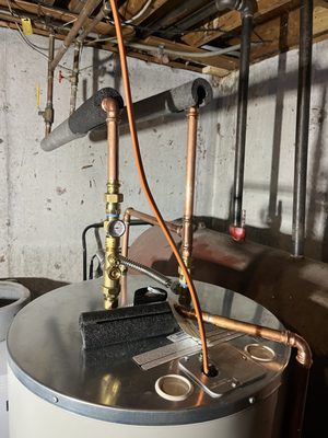 New water heater with tank mixer and piping