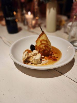 Poached pear with dulce de leche ice cream.