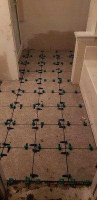 We offer professional tile install, as you can see we use a leveling system to make sure there is no lips and is installed correctly