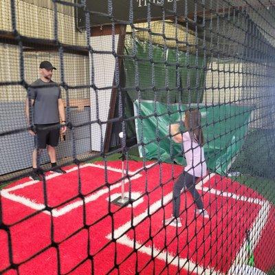 Grandaughter Sophia practicing with her Dad at Extreme Batting, Tifton, Ga.