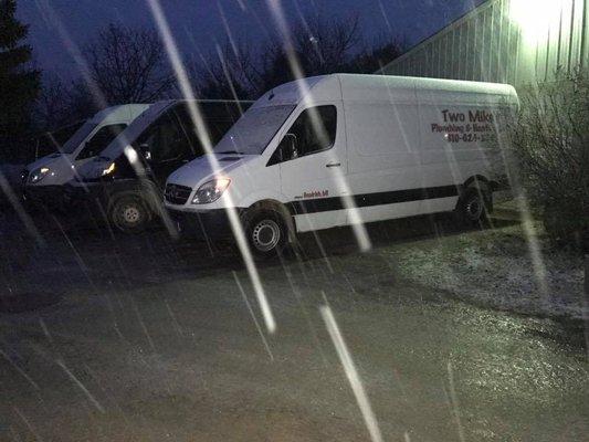 The vans waiting patiently in the snow to get the day started.