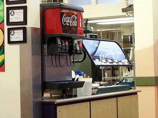 Note cleaning supplies with chemicals left in drink and condiments area with customers in the store.