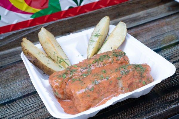 Stuffed cabbage in tomato sauce with garlic wedges potatoes