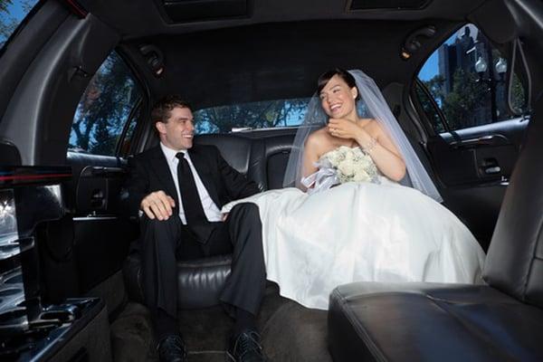 Newlyweds enjoying their VIP limo experience on their special day