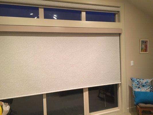 Large shade covering slider, with upper shade rolled up into matching fabric cassette