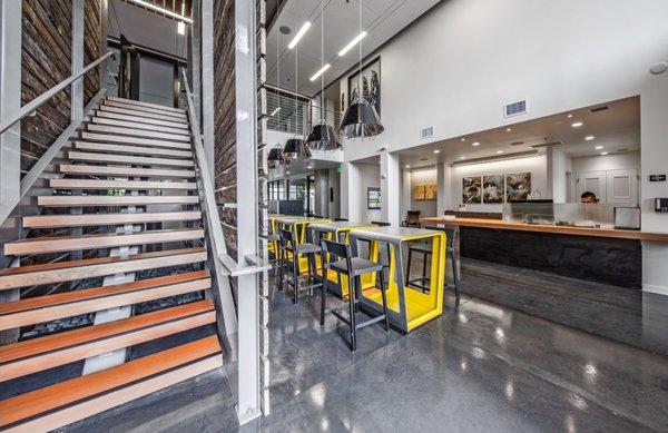 Lobby with concrete flooring and stairs up to the resident lounge.