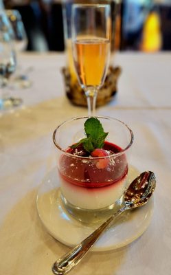 White chocolate panna cotta with raspberry coulis and shaved white chocolate