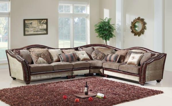 Beautiful formal sectional features nail head accents and contrasting bonded leather arms and back trim.