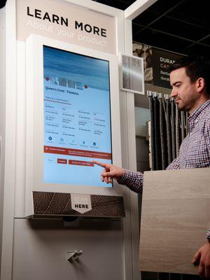 Sergenian's employee demonstrating new flooring kiosk.