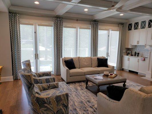 Living room drapery panels with solar shades on french doors