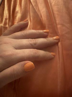 the final product - a well done simple tangerine gel on a natural nail