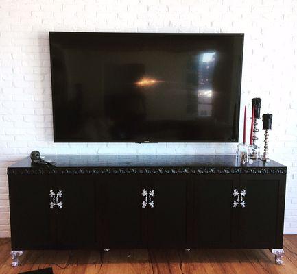 Custom designed tv console houses complete surround sound and all equipment