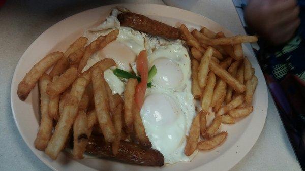 Eggs, sausage,  and fries with 2 extra eggs.