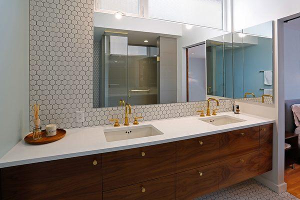 Mid century modern style with gold touches and a wood vanity.