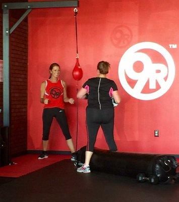 Personal trainer with every workout. "Red" teaching the technique on the double end bag.