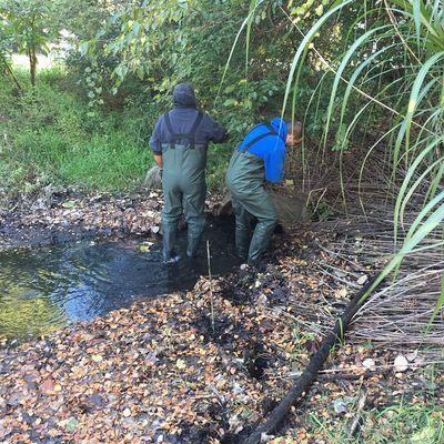 Cleaning a culvert that goes under a road from one pond to another of accumulated dirt and debris for a Homeowners Association.