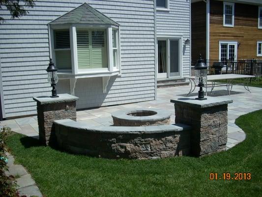 Fire pit with seating wall and piers with lights