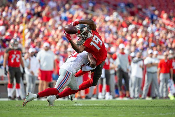 Tampa Bay Buccaneers wide receiver Breshad Perriman (19) is hit by New York Giants cornerback Deandre Baker (27).