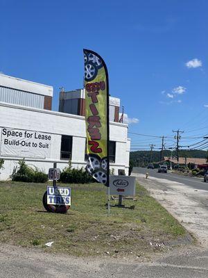 Used tire flag in front of parking lot