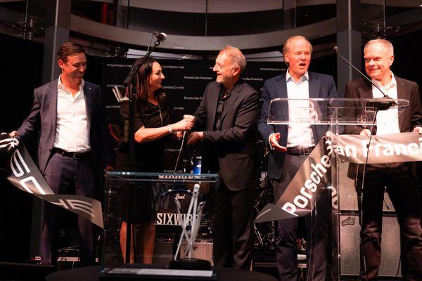 Porsche Executives on stage cutting the ribbon at Porsche San Francisco Grand Opening