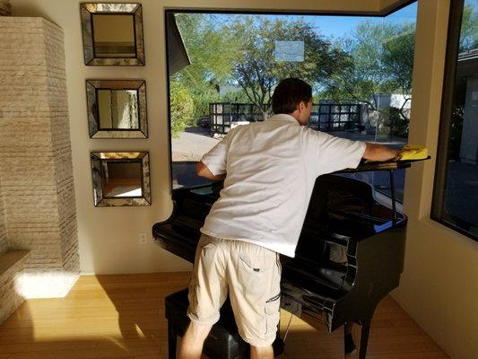 Daniel polishing up a baby grand