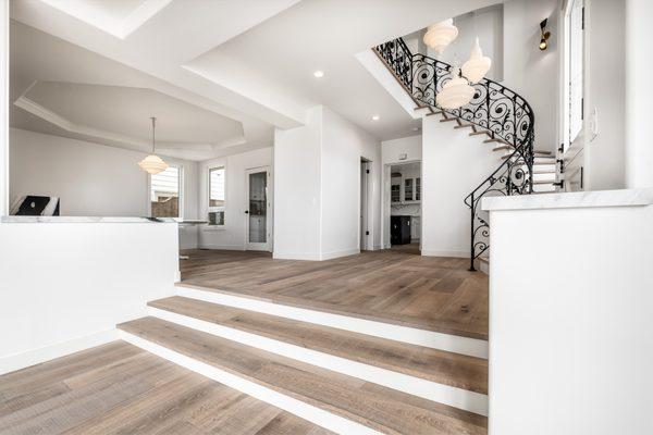 Foyer: custom milled stair treads and nosings installed along the curved staircase, newly remodeled walls, new chandeliers