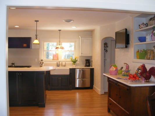 West end of kitchen after combining rooms and hall to make larger room. New hardwood floor. New lighting.